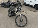 motorcycles parked in a parking lot next to a white van
