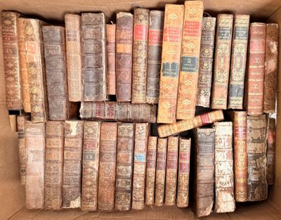 a box full of old books sitting on the floor