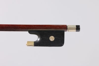 a violin bow on a white surface with a white background