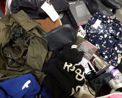 a pile of clothes and other items on the floor