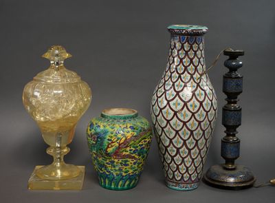 three vases and a lamp on a table