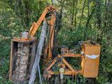 a yellow machine that is sitting in the woods