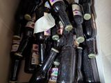 a box full of empty beer bottles sitting on the floor