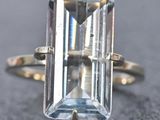 a close up of a ring with an aquamarine stone in it