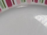 a white plate with pink and green stripes on it