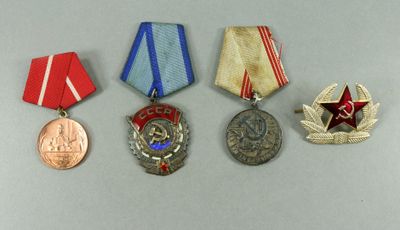 three medals and a medal on a white surface with a red star in the middle