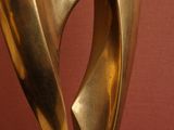 a close up of a gold sculpture on a red surface