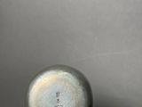 a close up of a metal object on a wooden stand