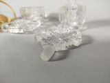 several pieces of glass sitting on top of a table next to a basket