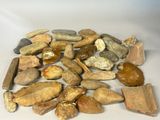some rocks and stones are arranged on a white surface