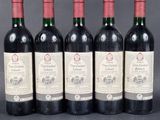 six bottles of wine are lined up in a row
