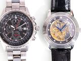 two watches that are sitting side by side on a white surface