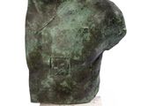 statue of a man ' s head on a marble base on a white surface