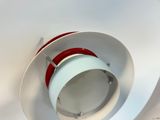 a white toilet with a red seat and a white toilet bowl
