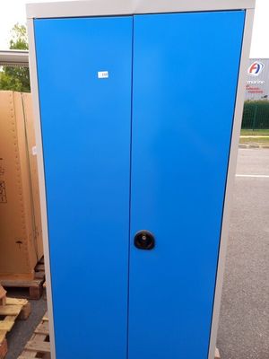 a blue cabinet sitting on a pallet in a parking lot