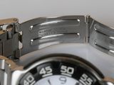 a close up of a watch on a white surface