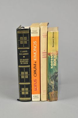 three books are stacked on top of each other on a table