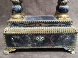 a black and gold box with two birds on it