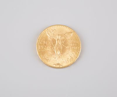 a close up of a gold coin on a white surface