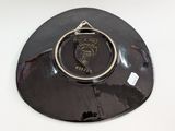 a black plate with a gold ring on top of it