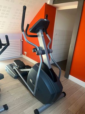a gym room with a treadmill and a stationary bike