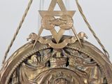 a gold clock with a star of david on it