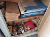 a cabinet with a lot of papers and other items in it