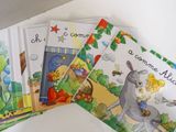 several children ' s books are lined up on a table