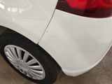 a close up of a white car with a red tail light