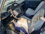 a dirty car that is sitting in the dirt