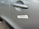 a close up of a car door handle with a sticker on it