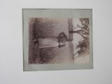 a black and white photo of a woman standing in the rain