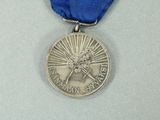 silver medal with a blue ribbon around it and a picture of a tree