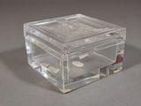 a clear glass box with a lid on a table