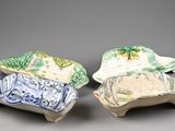 two ceramic dishes with designs on them on a gray surface