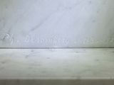 a close up of a white marble statue with writing on it