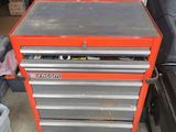 an orange tool box sitting on top of a table in a garage