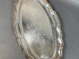 a silver tray with a mirror on it on a table