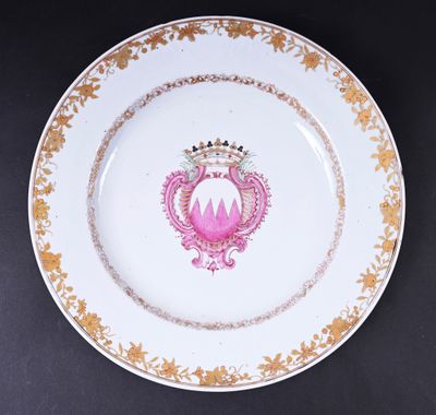 une assiette rose et dorée ornée d'une couronne