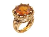 a close up of a ring with an orange stone on it