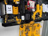 des outils jaunes et noirs dans un coffret noir posé sur une surface blanche