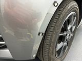 a close up of a car ' s front bumper and tire