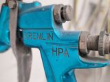 a close up of a blue spray gun on a table