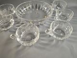 a lot of glass bowls and cups on the table