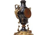 a blue and gold vase sitting on top of a stand