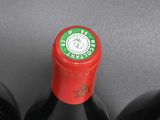 three bottles of red wine sitting on top of a table