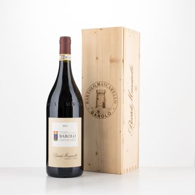 a bottle of wine sitting next to a wooden box