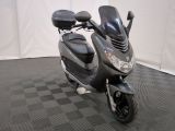 un scooter garé sur un sol à carreaux noirs et blancs