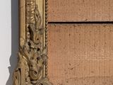 a picture of a picture of a gold frame on the wall