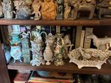 une étagère sur laquelle sont disposées de nombreuses figurines de toutes sortes